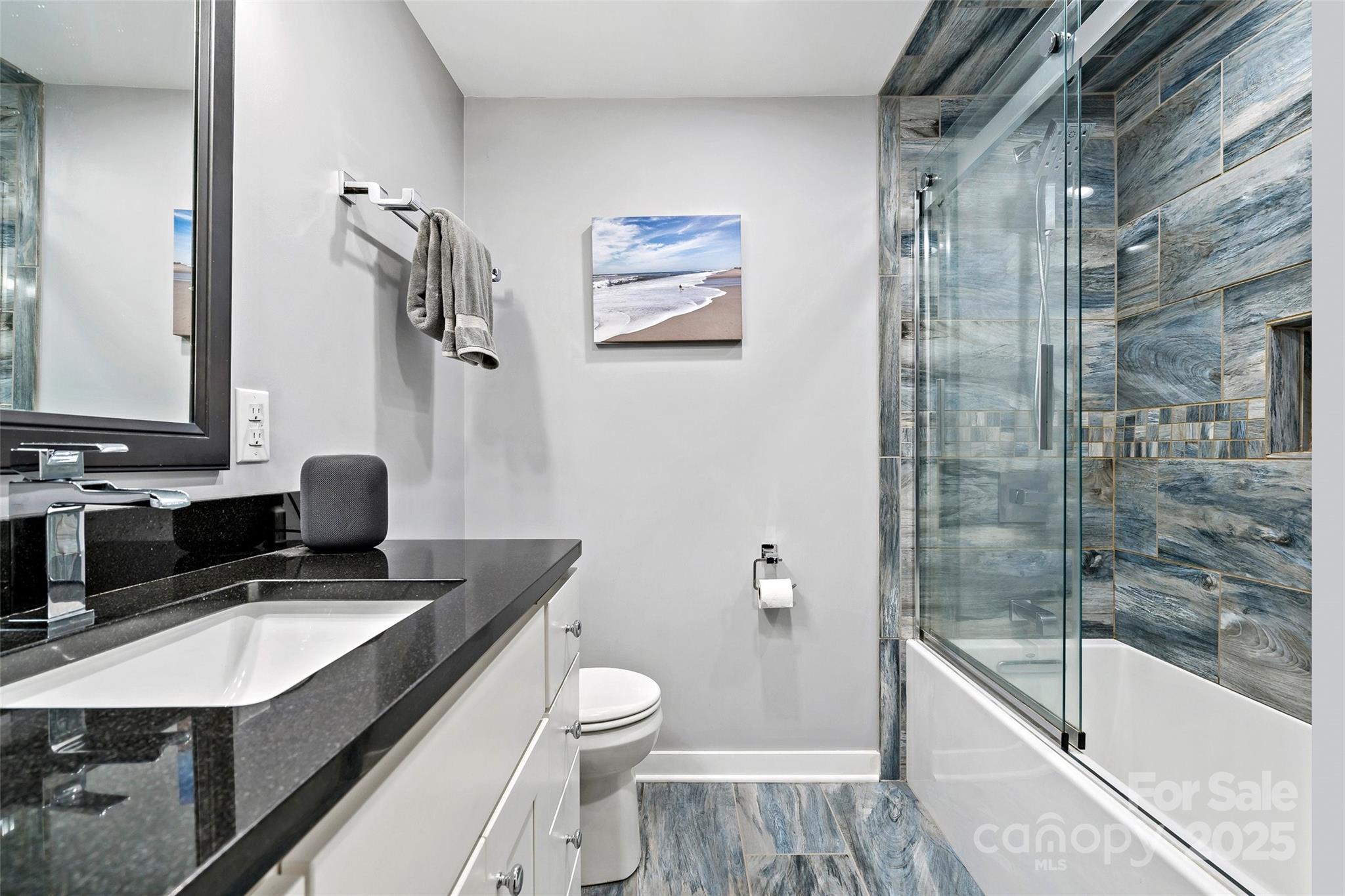 692 Hidden Acres Drive Marion, NC 28752 - Photo 35 of 48 a bathroom with a granite countertop sink toilet and shower