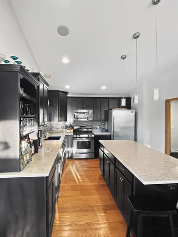 a dining room with furniture a chandelier and wooden floor