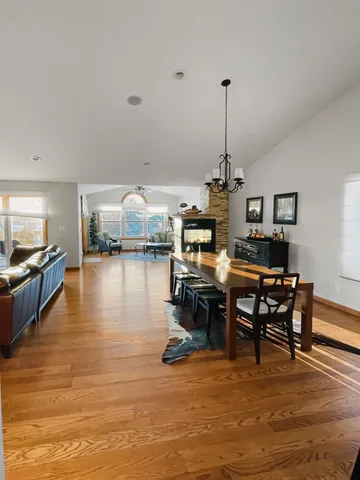 a large kitchen with a table and chairs in it