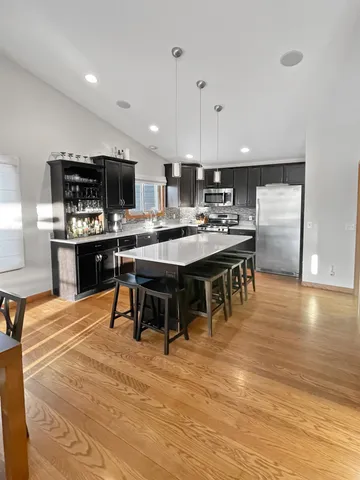 a living room with furniture and kitchen view