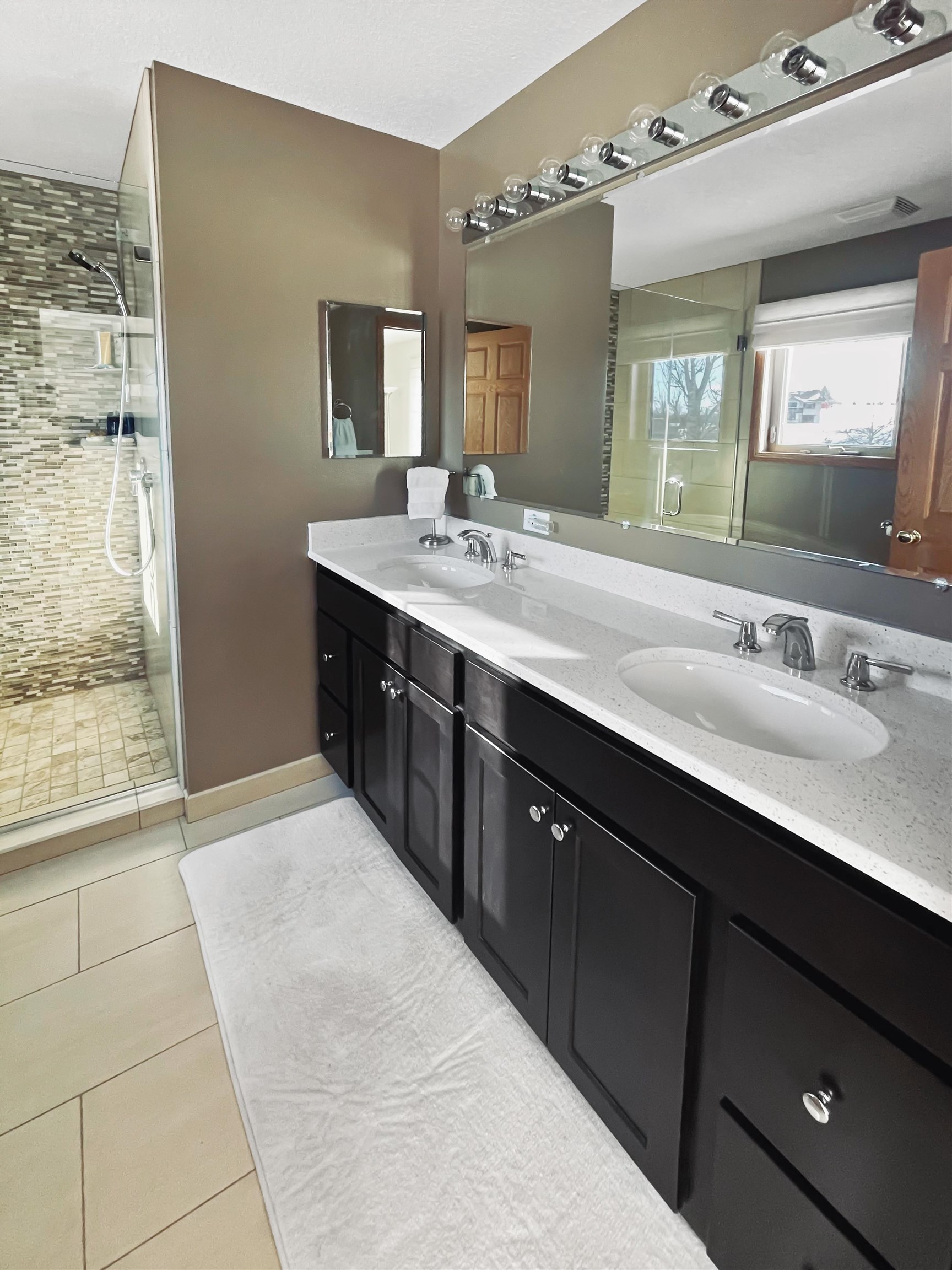 27-54 Ridgeview Drive Lake Carroll, IL 61046 - Photo 20 of 58 a spacious bathroom with a double vanity sink a mirror and a shower