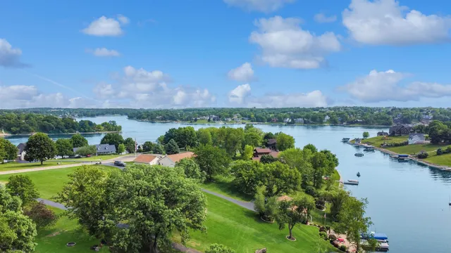 a view of a lake with houses in back