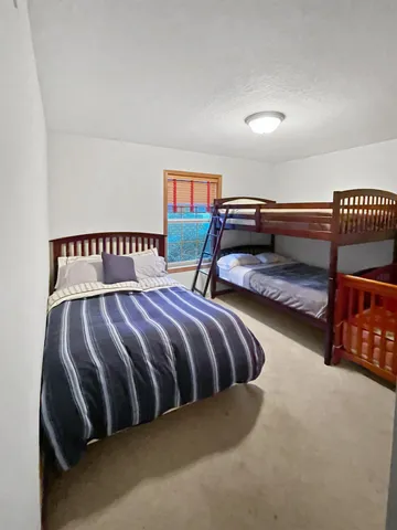 a bedroom with a bed and a large mirror