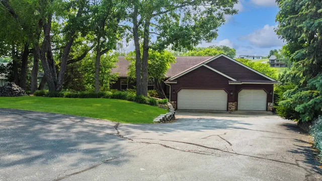 a house with green field in front of it