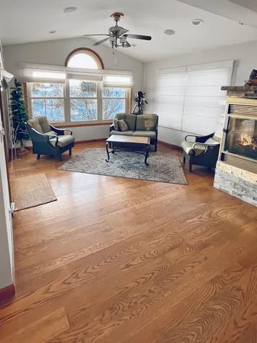 a living room with a rug and a fireplace