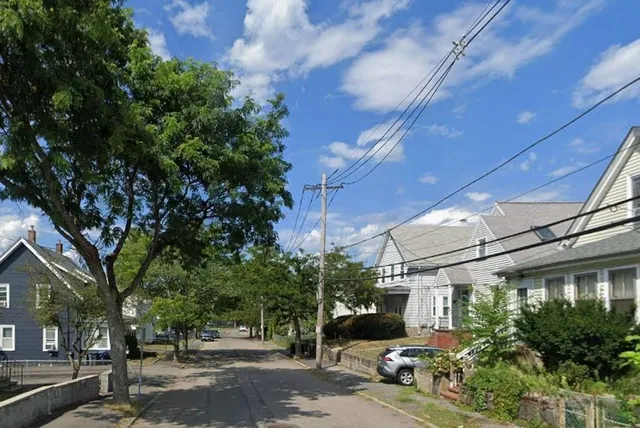 a view of street with parked cars