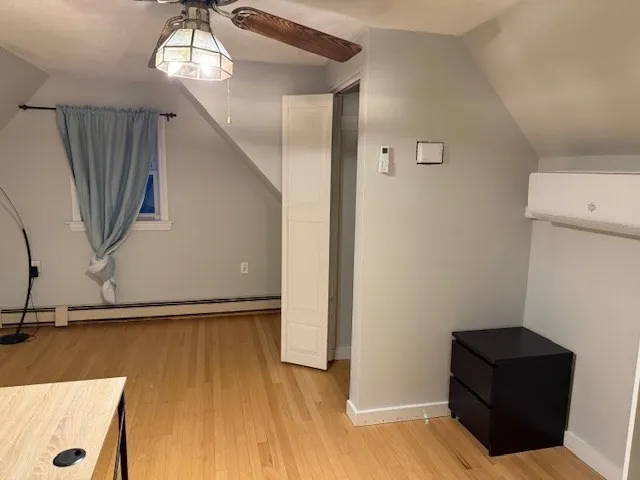 a view of a livingroom with wooden floor and staircase