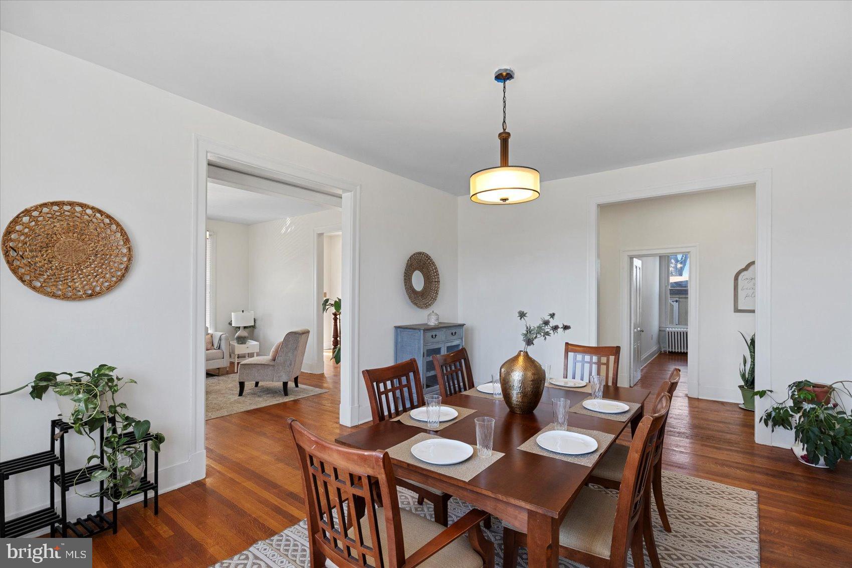 6602 Krone Drive Baltimore, MD 21207 - Photo 14 of 49 a dining room with furniture a mirror and wooden floor