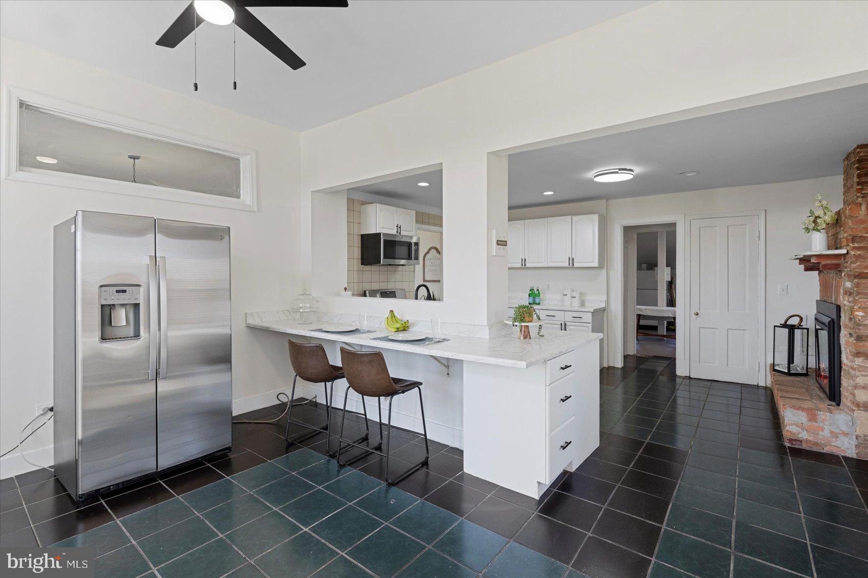 6602 Krone Drive Baltimore, MD 21207 - Photo 20 of 49 a large white kitchen with a sink stainless steel appliances and cabinets