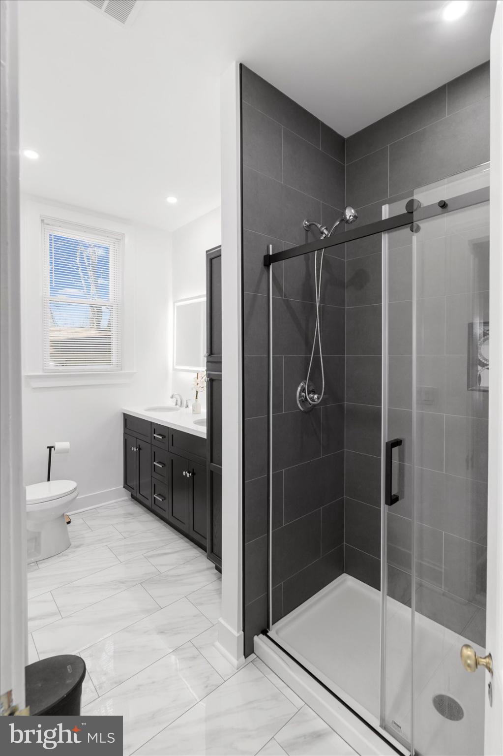 6602 Krone Drive Baltimore, MD 21207 - Photo 26 of 49 a bathroom with a double vanity sink toilet and shower