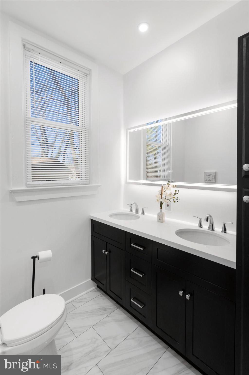 6602 Krone Drive Baltimore, MD 21207 - Photo 27 of 49 a bathroom with a double vanity sink and mirror