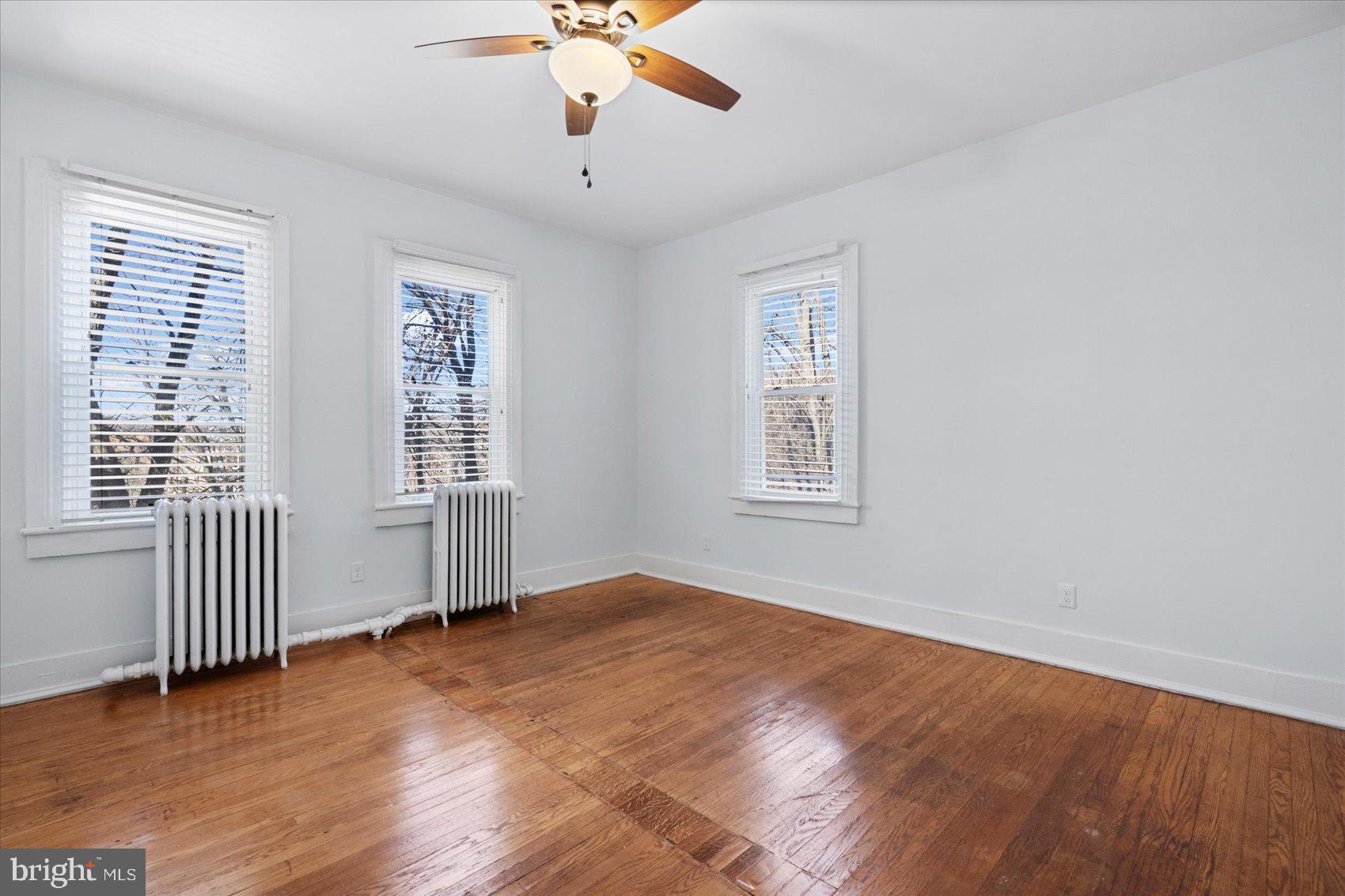 6602 Krone Drive Baltimore, MD 21207 - Photo 30 of 49 an empty room with wooden floor and windows