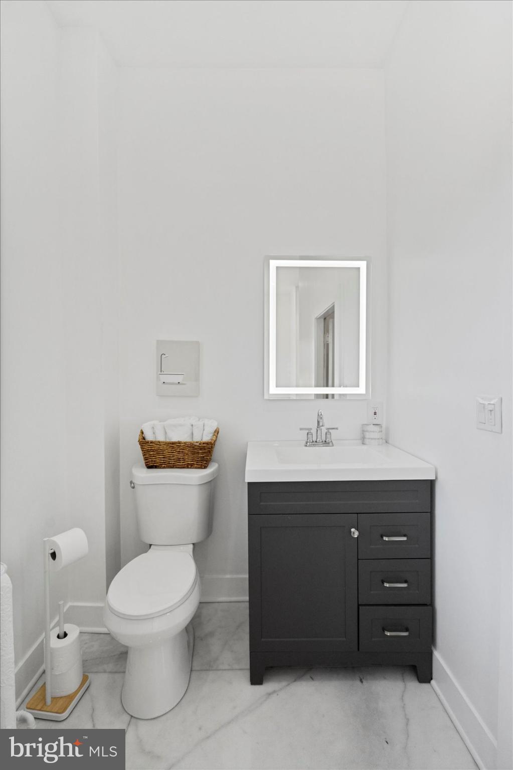 6602 Krone Drive Baltimore, MD 21207 - Photo 37 of 49 a bathroom with a toilet sink and mirror