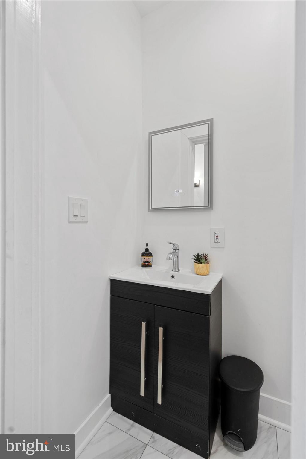 6602 Krone Drive Baltimore, MD 21207 - Photo 38 of 49 a bathroom with a sink and a mirror