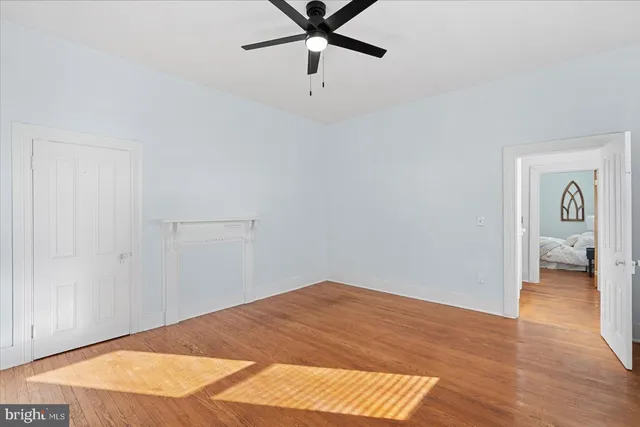 a view of empty room with wooden floor