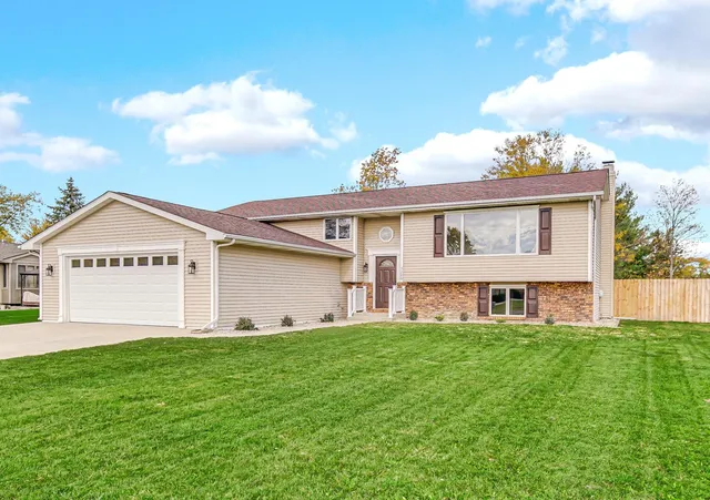 a view of a house with a yard and pathway