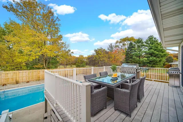 a view of a balcony with wooden floor and outdoor seating