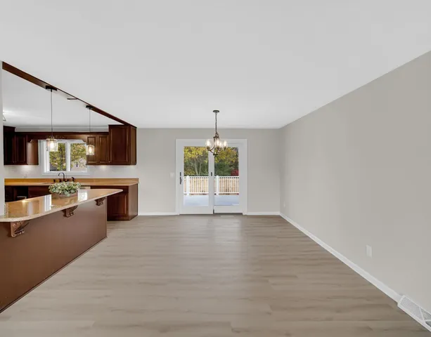 a view of a kitchen with a sink dishwasher and a fireplace