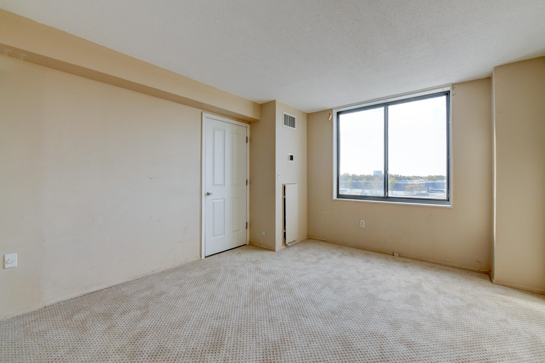232 Harmon Cove Tower, Unit 232 Secaucus, NJ 07094 - Photo 11 of 47 a view of an empty room with a window