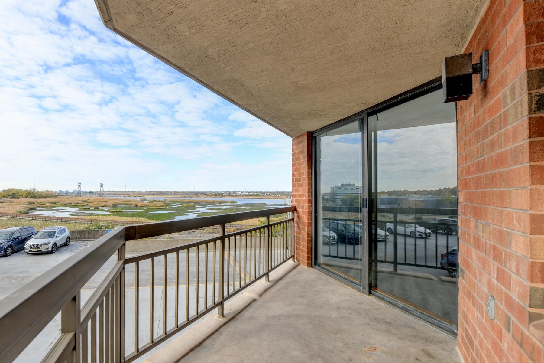 232 Harmon Cove Tower, Unit 232 Secaucus, NJ 07094 - Photo 12 of 47 a view of a city from a balcony