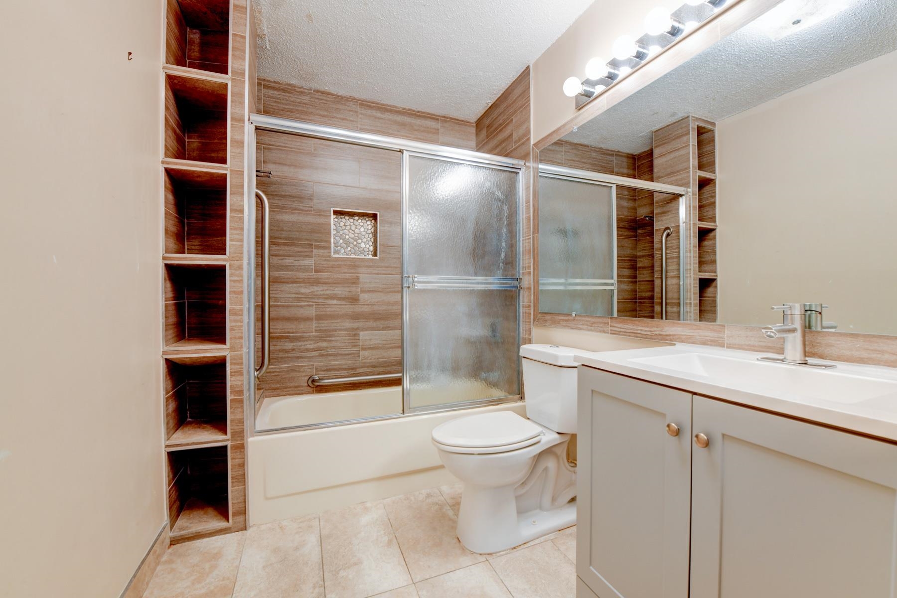 232 Harmon Cove Tower, Unit 232 Secaucus, NJ 07094 - Photo 17 of 47 a bathroom with a granite countertop sink a toilet and shower