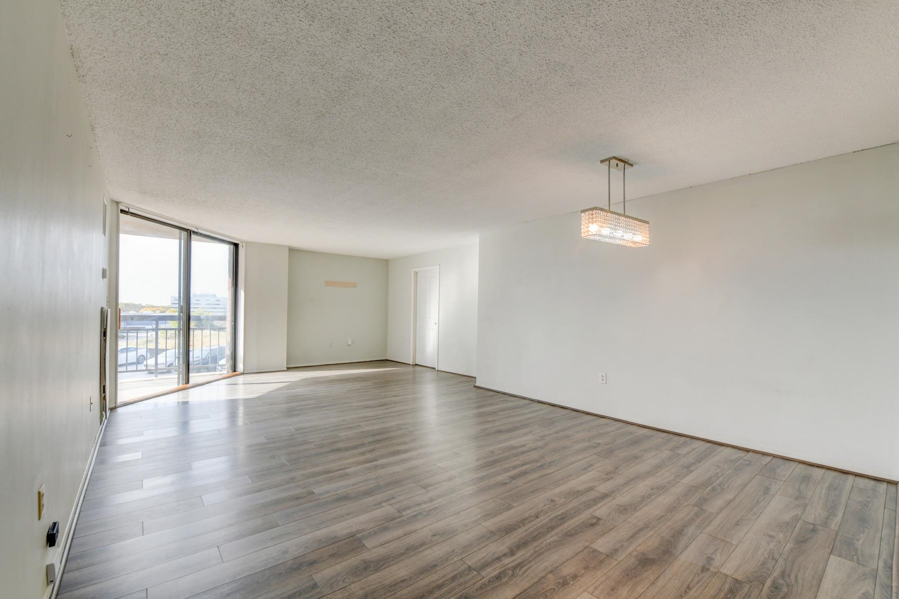 232 Harmon Cove Tower, Unit 232 Secaucus, NJ 07094 - Photo 4 of 47 a view of an empty room with wooden floor and a window