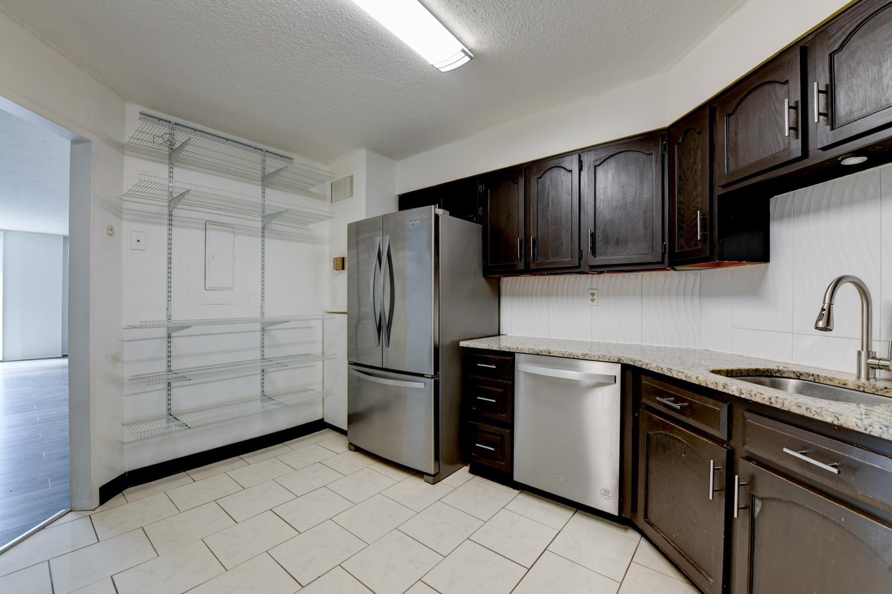 232 Harmon Cove Tower, Unit 232 Secaucus, NJ 07094 - Photo 7 of 47 a kitchen with stainless steel appliances granite countertop a refrigerator and a sink