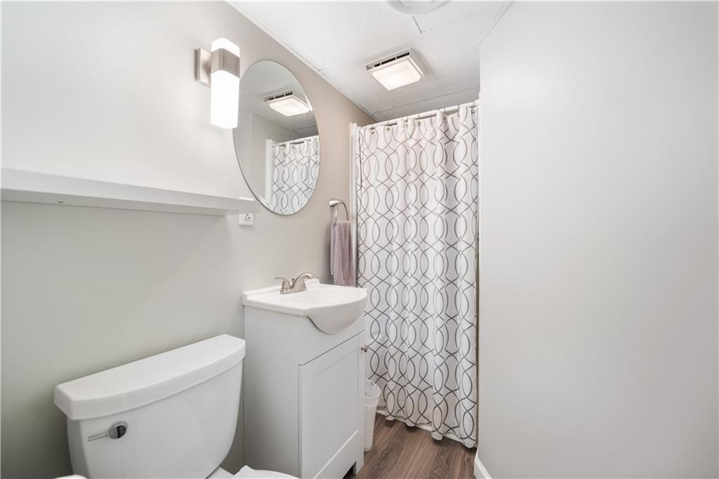 1002 Sundance Drive McKees Rocks, PA 15136 - Photo 22 of 25 a bathroom with a toilet a sink and a shower curtain
