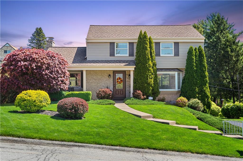 1002 Sundance Drive McKees Rocks, PA 15136 - Photo 25 of 25 a front view of a house with a garden and plants