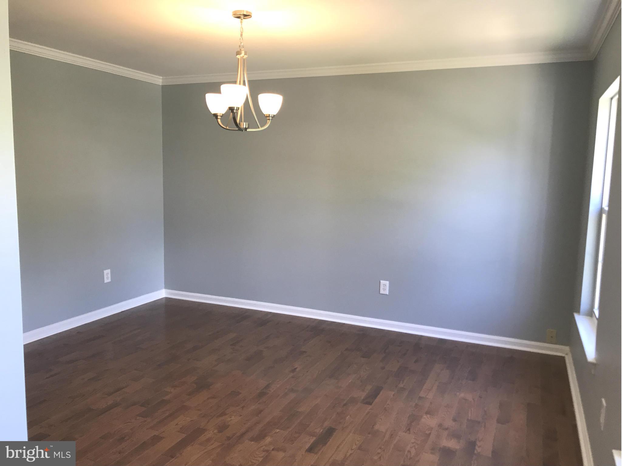 12611 Holdridge Road Silver Spring, MD 20906 - Photo 4 of 21 a view of empty room with wooden floor and fan