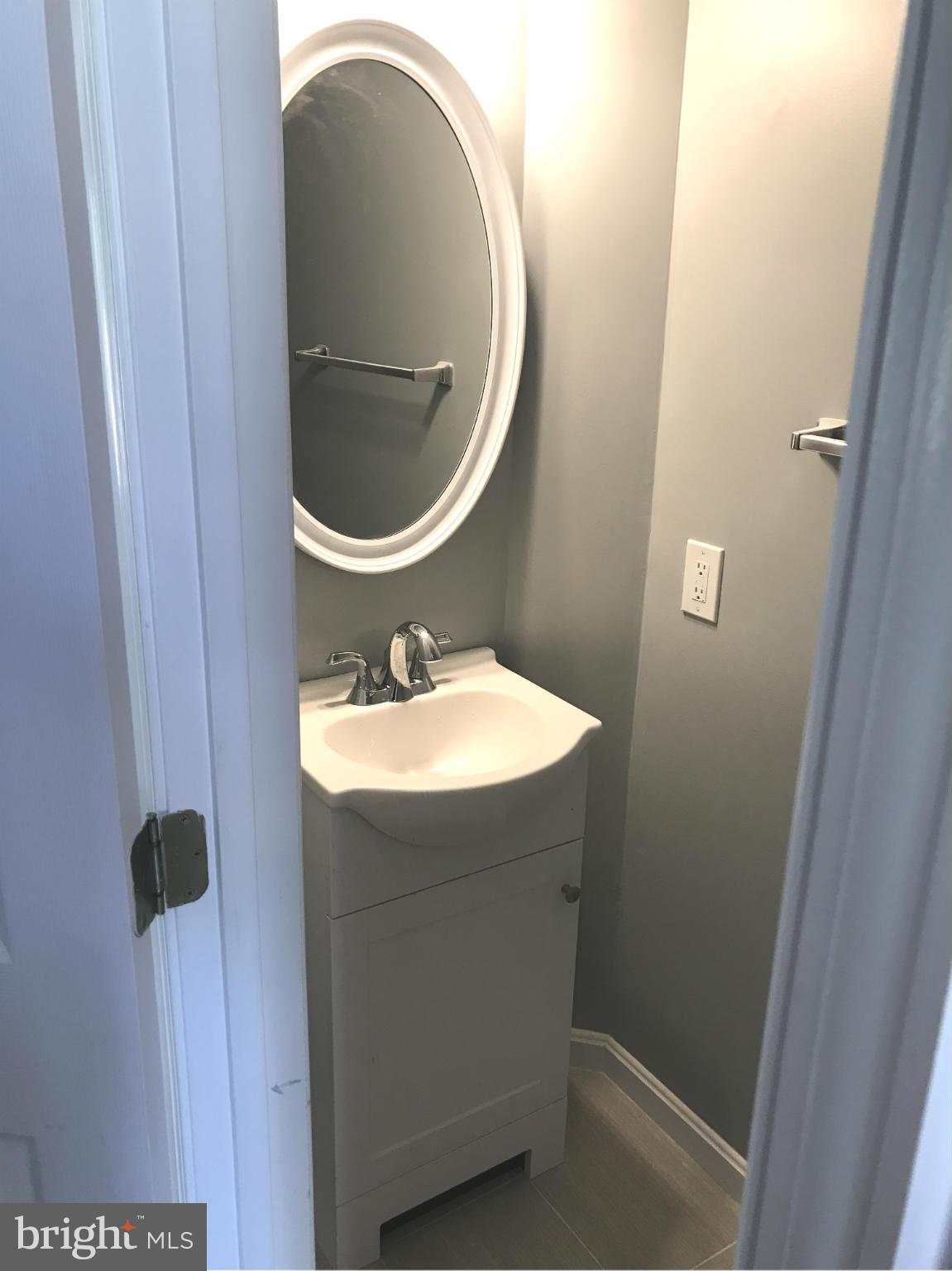 12611 Holdridge Road Silver Spring, MD 20906 - Photo 5 of 21 a bathroom with a sink and a mirror