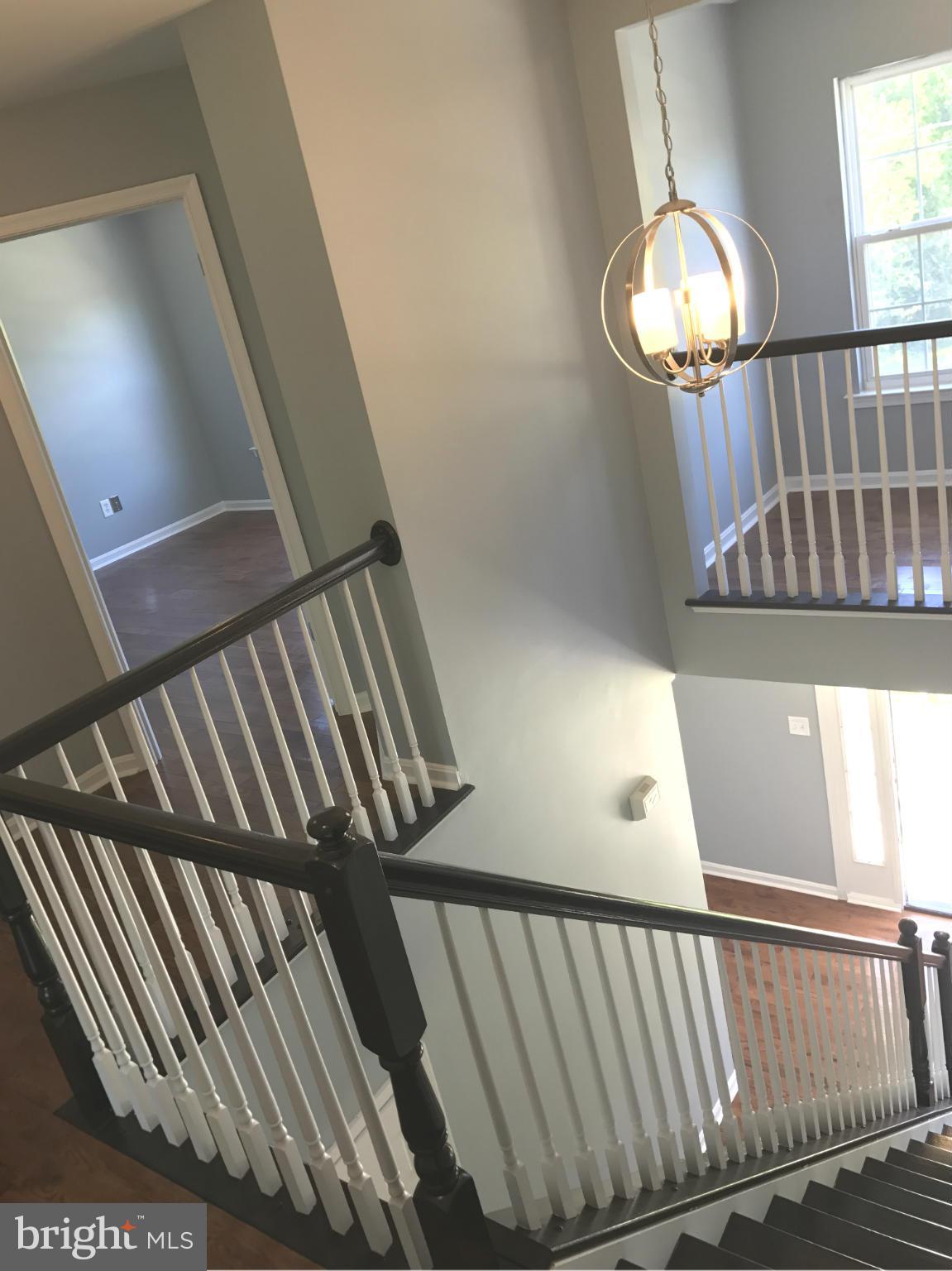 12611 Holdridge Road Silver Spring, MD 20906 - Photo 8 of 21 a view of staircase with railing and a chandelier