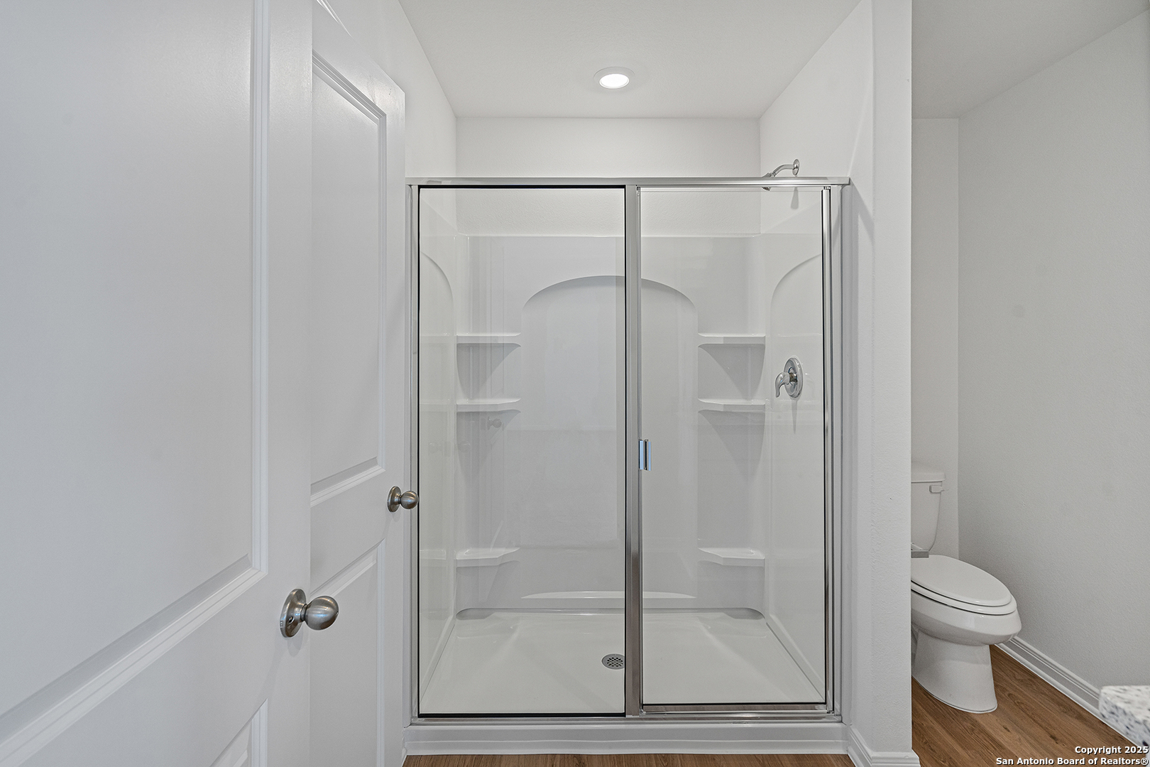 16148 Farmer Lytle, TX 78052 - Photo 15 of 33 a bathroom with a glass shower door
