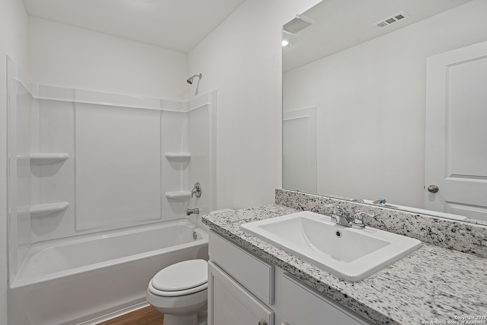 16148 Farmer Lytle, TX 78052 - Photo 19 of 33 a bathroom with a sink toilet vanity and shower