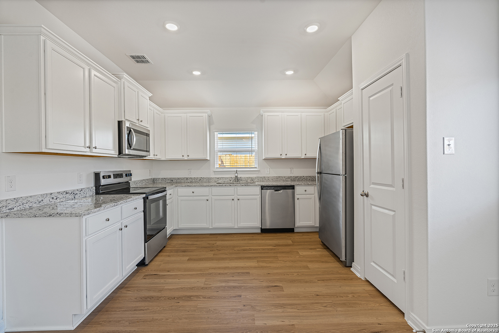 16148 Farmer Lytle, TX 78052 - Photo 7 of 33 a kitchen with stainless steel appliances granite countertop a refrigerator sink and cabinets