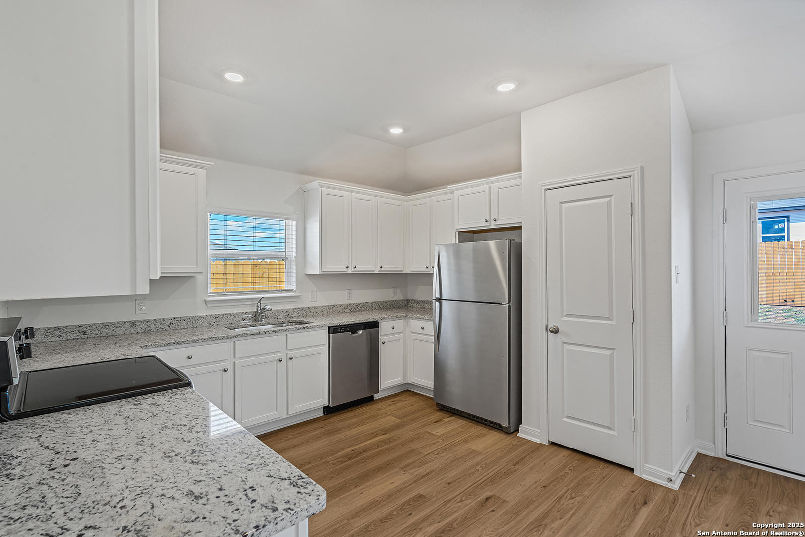 16148 Farmer Lytle, TX 78052 - Photo 8 of 33 a kitchen with a refrigerator sink and cabinets