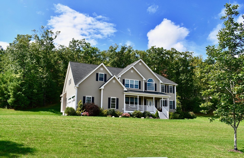 92 Robin Hill Road Groton, MA 01450 - Photo 1 of 30 a front view of a house with a garden
