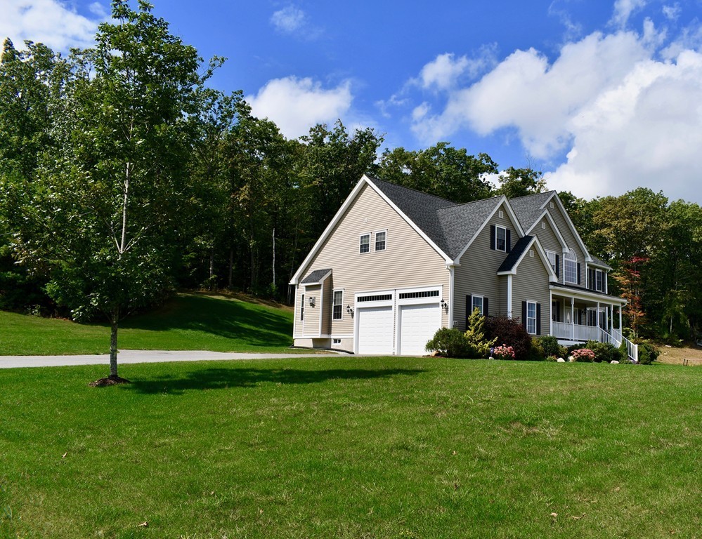 92 Robin Hill Road Groton, MA 01450 - Photo 2 of 30 a front view of a house with a yard