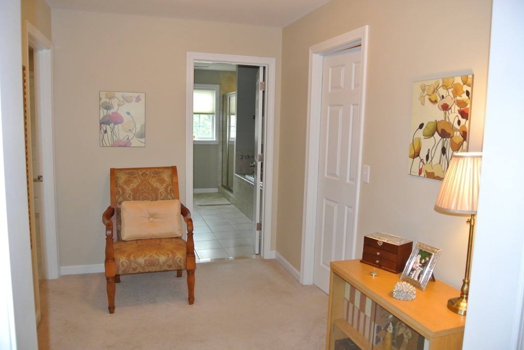 92 Robin Hill Road Groton, MA 01450 - Photo 21 of 30 a room that has a bed and a chair in it