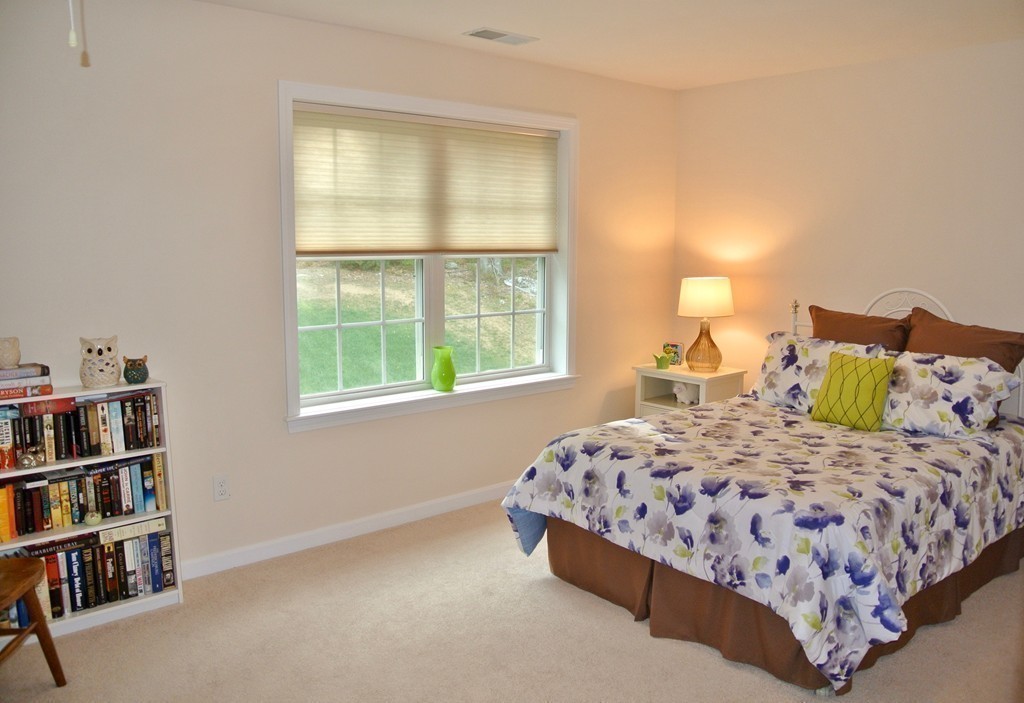 92 Robin Hill Road Groton, MA 01450 - Photo 29 of 30 a bedroom with a bed and a book shelf