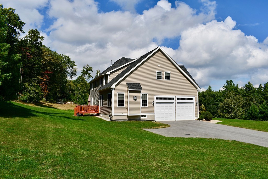 92 Robin Hill Road Groton, MA 01450 - Photo 3 of 30 a front view of house with yard and green space