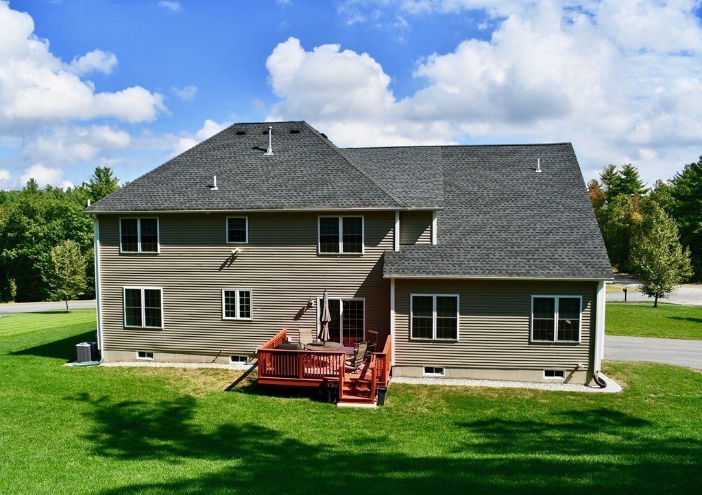 92 Robin Hill Road Groton, MA 01450 - Photo 4 of 30 a front view of a house with a garden and yard