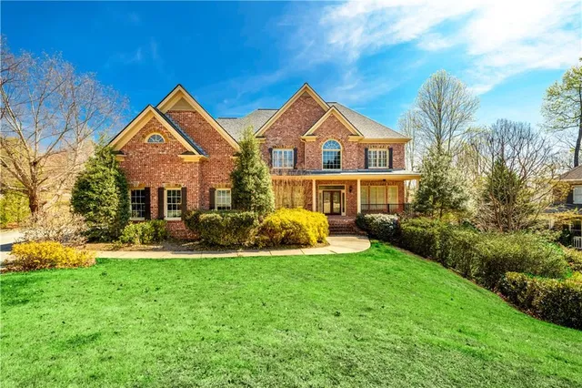 a front view of a house with a yard
