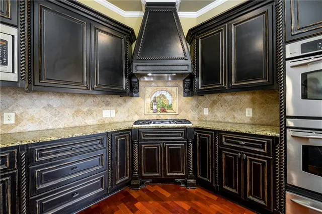 a kitchen with granite countertop a stove and a microwave