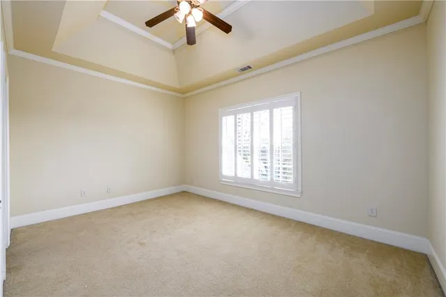 an empty room with ceiling fan