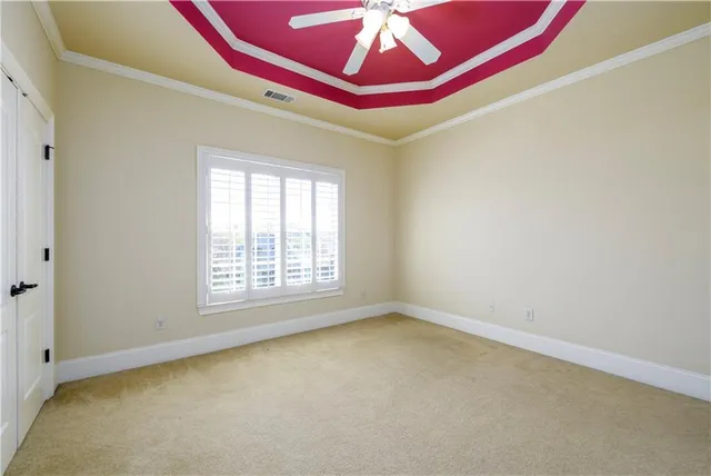 a view of a livingroom with a chandelier fan and a bathroom