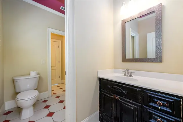 a kitchen with stainless steel appliances kitchen island granite countertop a stove a refrigerator a sink a dining table and chairs with wooden floor