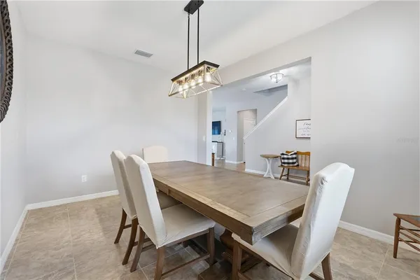 a view of a dining room with a table and chairs