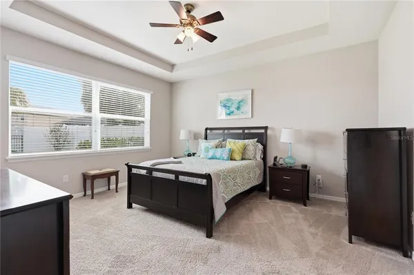 a bedroom with a bed dresser and window
