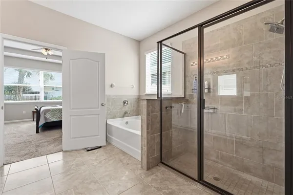 a bathroom with a tub mirror and shower
